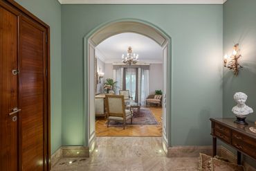 Pale blue hall with antique console and gilt mirror — تصميم مداخل فيلات