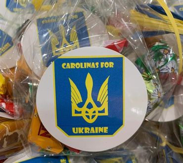 Candy bags with "Carolinas for Ukraine" stickers and yellow ribbons.