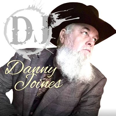 Bearded man in a cowboy hat and suit jacket looking to the side.