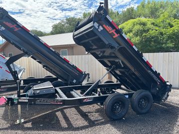 Dump trailer with raised bed in a yard.