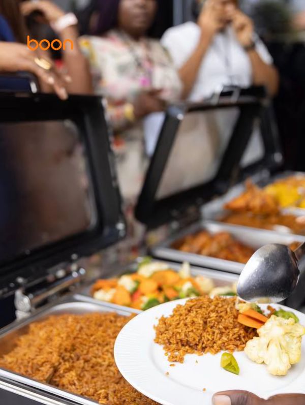 Serving rice and vegetables from a buffet.