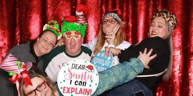 Co-workers having fun in a photo booth for the company holiday party in Phoenix
