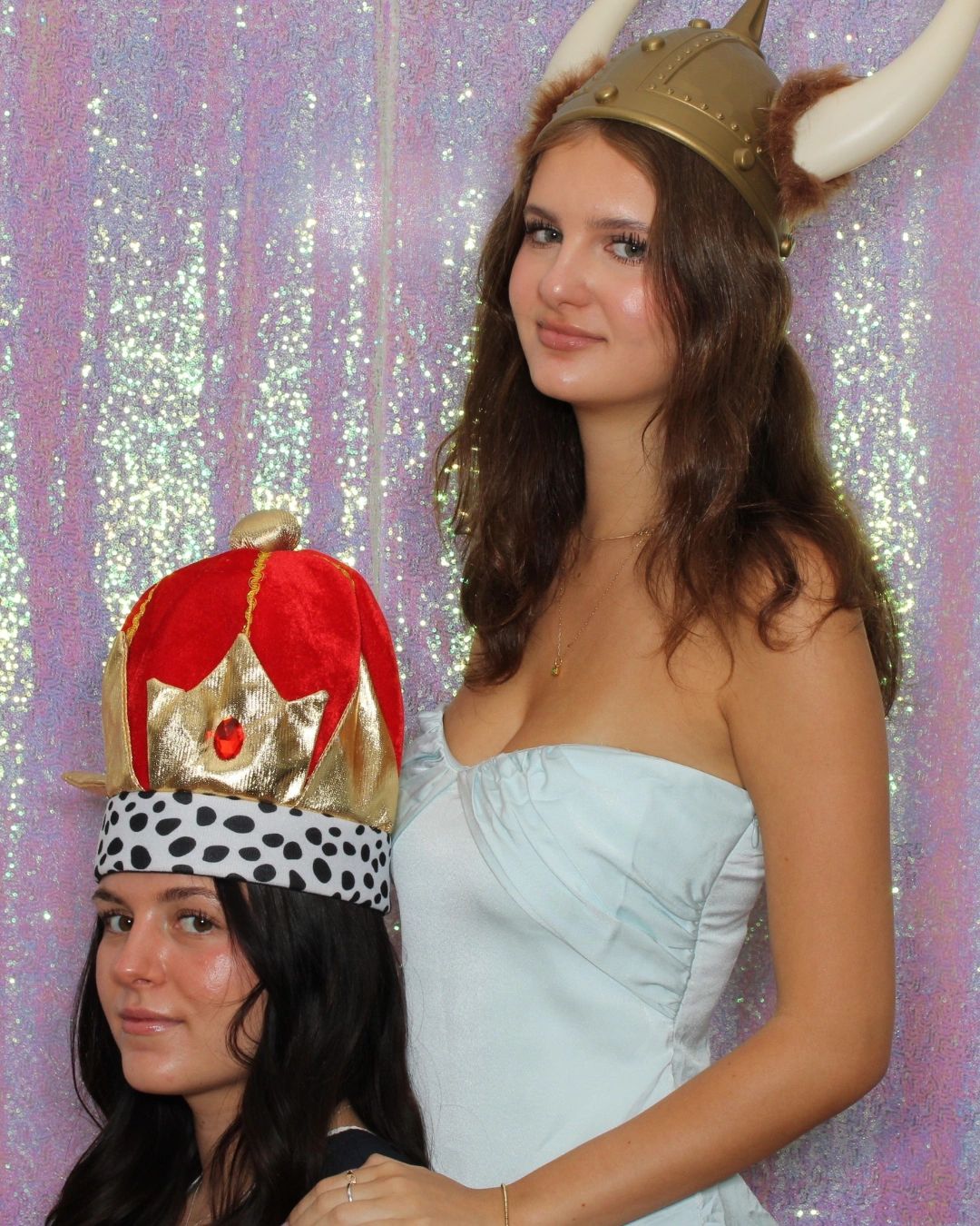 Friends wear goofy hats in a graduation photo booth in Scottsdale, AZ