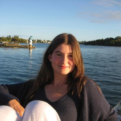Young woman relaxing by the water on a sunny day.