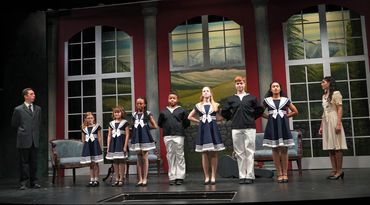 A group of people standing on top of a stage.