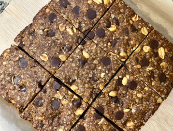 Homemade chocolate chip and oat bars cut into squares.