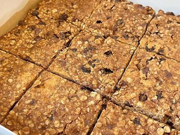 Freshly baked oatmeal raisin bars cut into squares.
