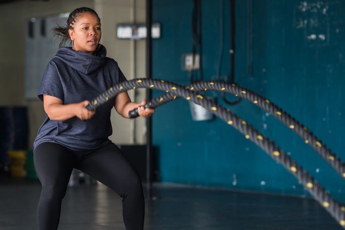 Plus size blue short sleeved athletic hoodie, battle ropes, gym, boxing