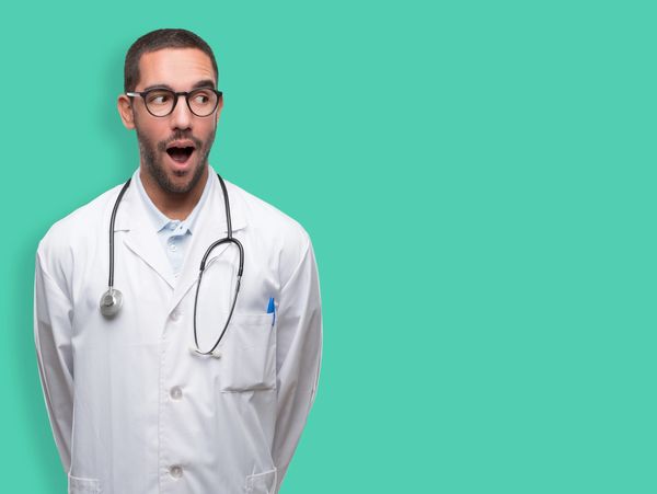 Caucasian doctor with mouth open looking at text about online digital marketing for doctors