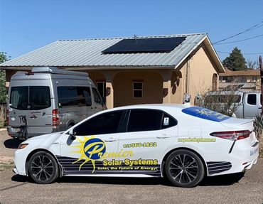 Premier Solar energy Car in front of a solar panel installation in Alpine, TX