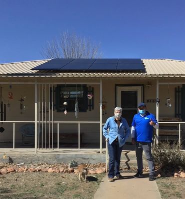solar rep with homeonwer outside the solar panel installation in alpine TX
