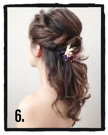 Half up and half down updo style with flower embellishments.