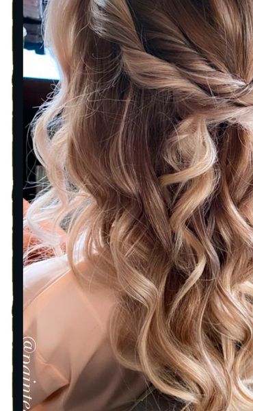 Twisted half up and half down and curled updo for prom hair, bridal hair or homecoming hair.