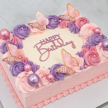 Square birthday cake with pink and purple frosting and butterfly decorations.
