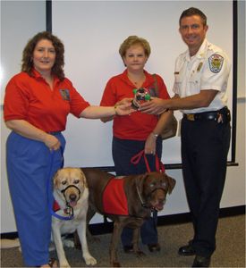 Club members presenting pet oxygen rescue mask set to a local fire department.