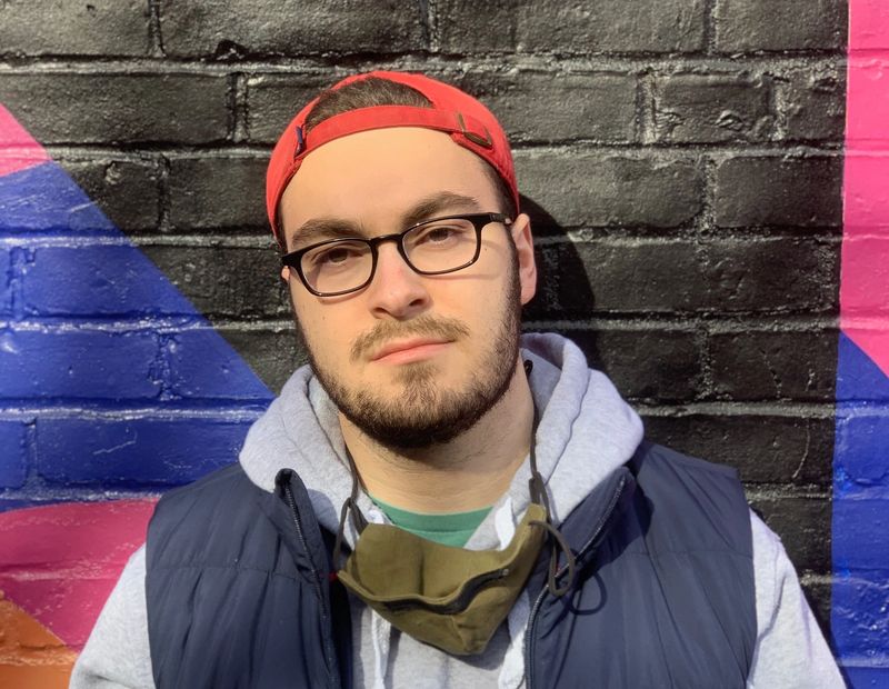 Zack Hurts rapper in front of cool wall