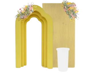 Decorative yellow arch with flowers and a white vase.