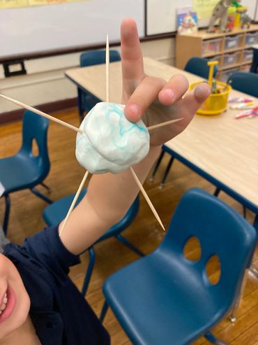Close-up of a child handling materials for an activity.