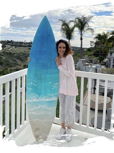Women holding blue surf boards