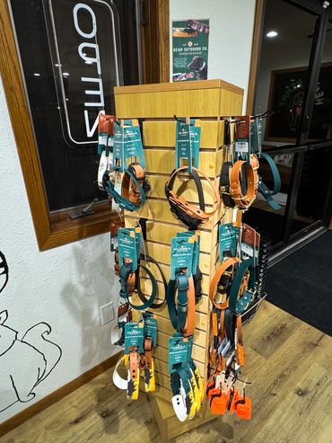 Display of handcrafted dog collars by Reign Outdoors Co. in a pet store.