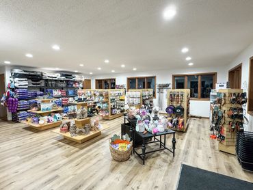 Brightly lit pet store interior with various pet supplies and accessories.