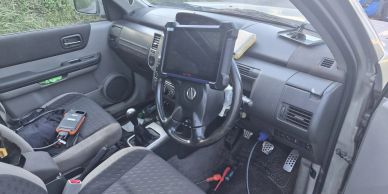Car interior with diagnostic equipment and tools.