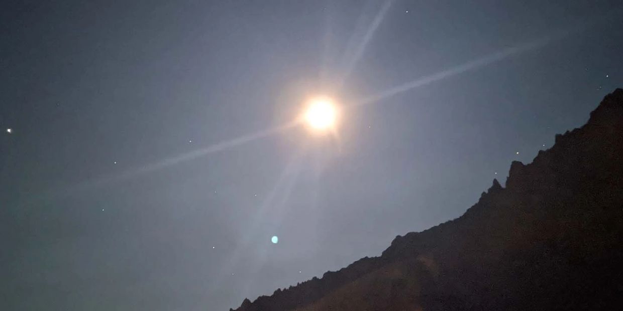 Full moon and stars over mountain
