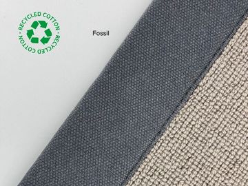 Close-up of recycled cotton fabric labeled 'Fossil' in gray and beige tones.