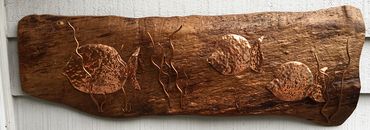 Hand hammered copper fish on walnut