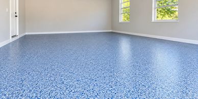 Empty room with blue speckled flooring.