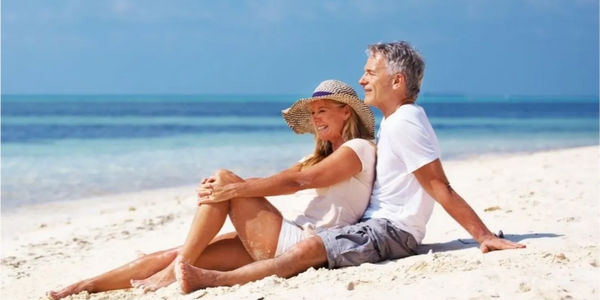 a couple relaxing on the sands of the beach