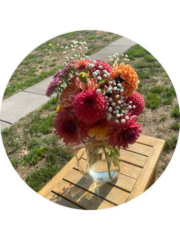 Bouquet of dahlias in various shades of orange, peach, pink and apricot.