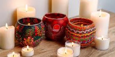 Decorative candles and candle holders on a wooden surface.