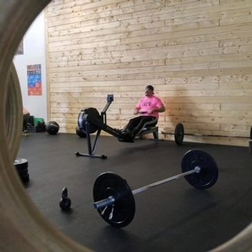 Man rowing in CrossFit gym