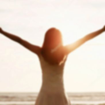 Girl embracing Sun on the beach