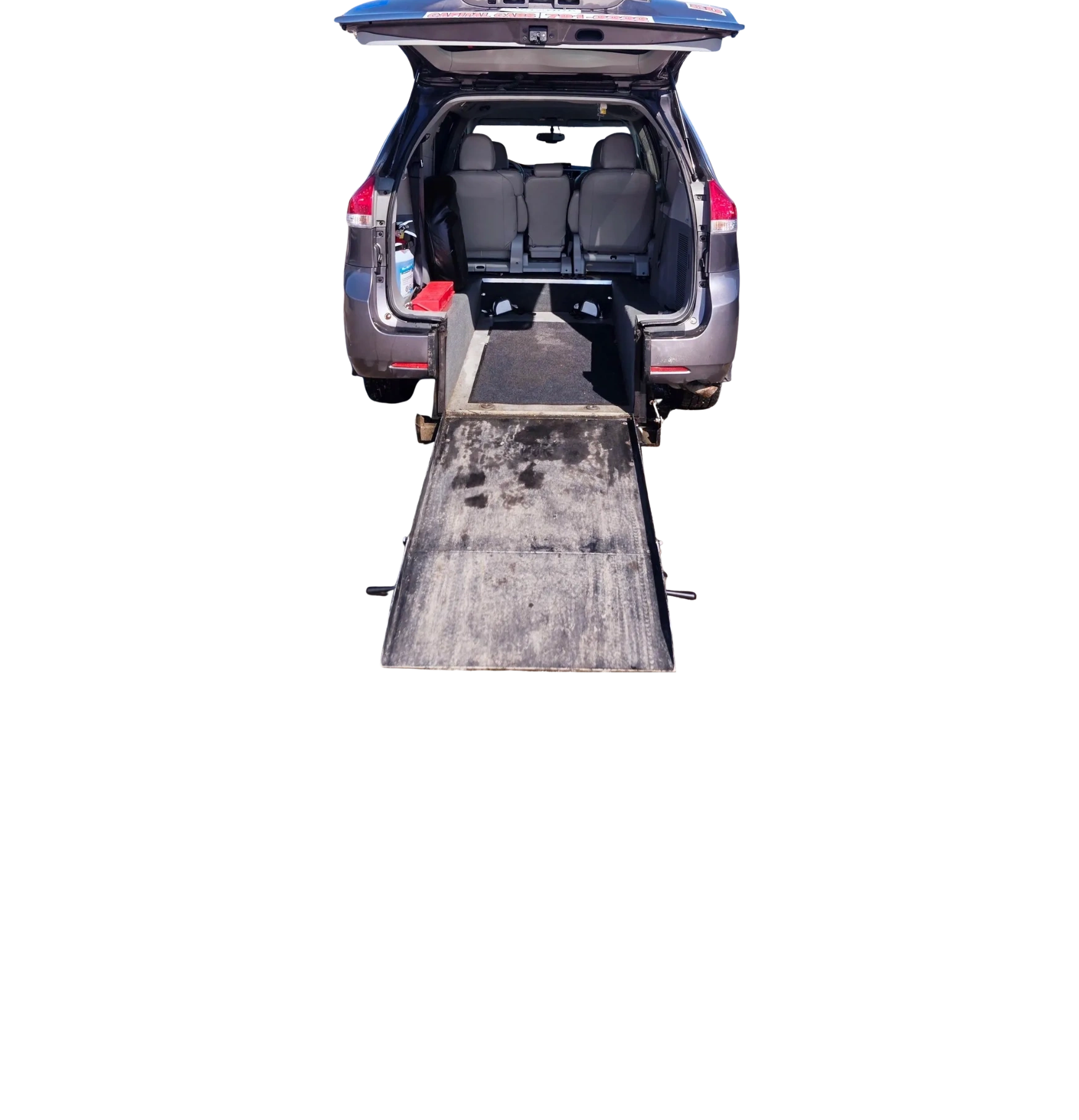Rear view of an SUV with a ramp extended for wheelchair access.