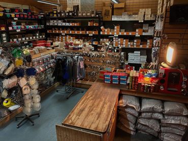 A small store with shelves full of various packaged goods and accessories.