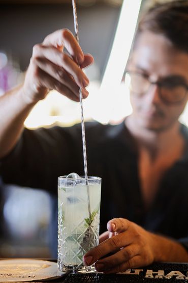 stirring a classic Mojito cocktail