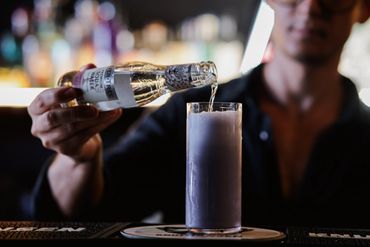 adding soda to a signature cocktail