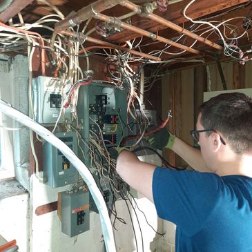 Doctor Electric team member servicing indoor electrical panel
