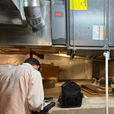 Upstate Air team member servicing indoor HVAC System