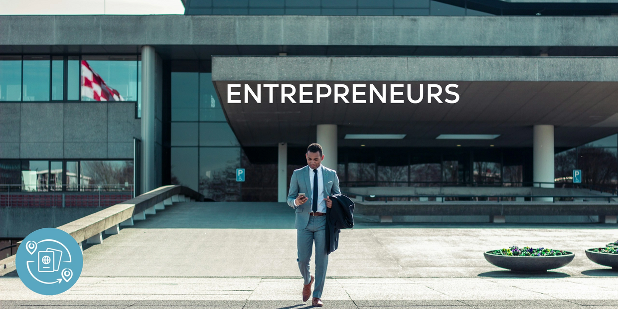 Businessman walking out of concrete office building with the words 'INVESTORS AND FOUNDERS'