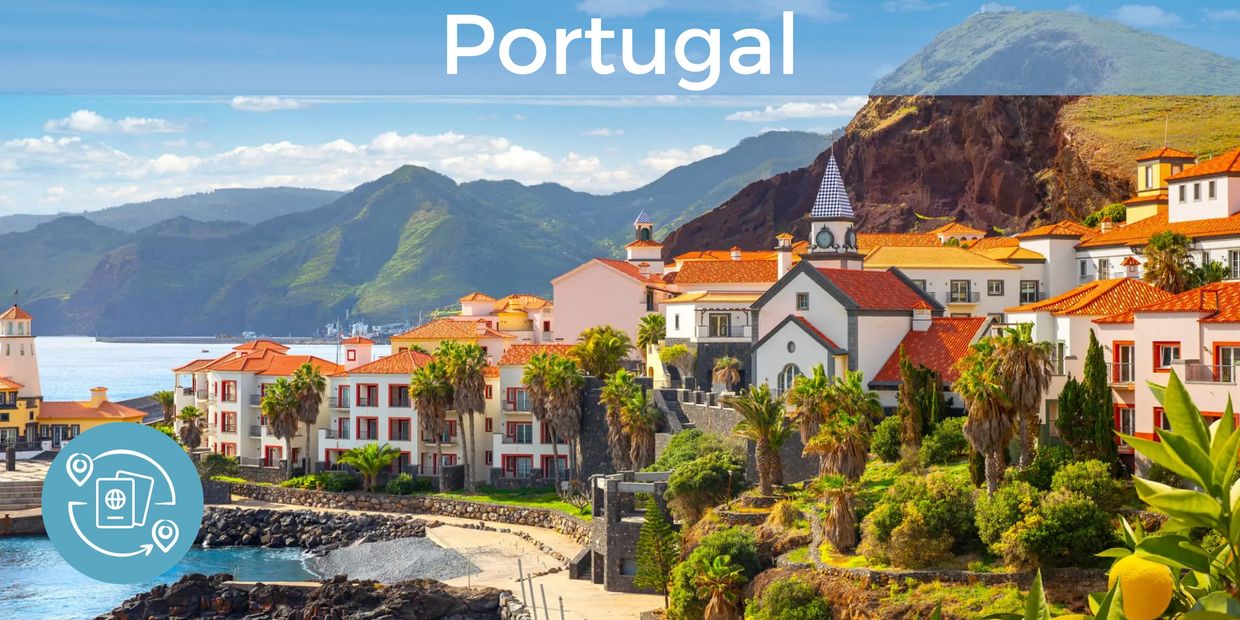 A coastal village in Portugal with palm trees and green mountains