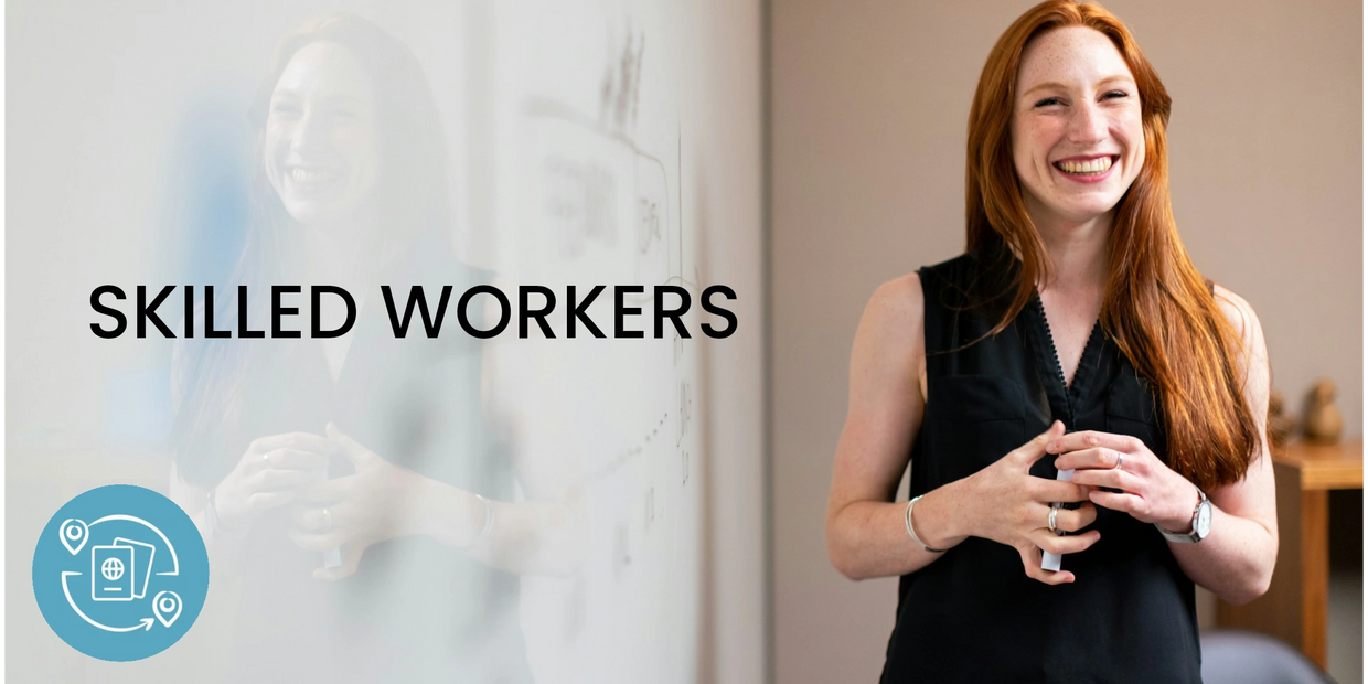 Smiling professional woman standing by a whiteboard with the word 'PROFESSIONALS'.