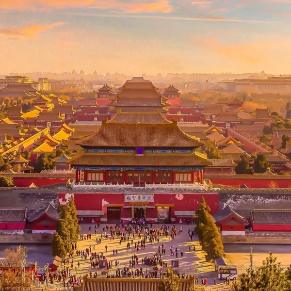 Sunset over the Forbidden City with crowds at the entrance.