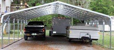 26x30x8 Texwin carport and trailer storage.  Installed on gravel driveway.