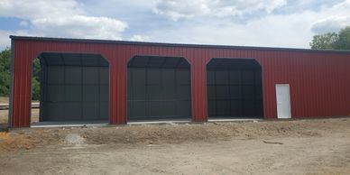 30x60x14 Texwin metal workshop and garage with 12x12 garage doors.