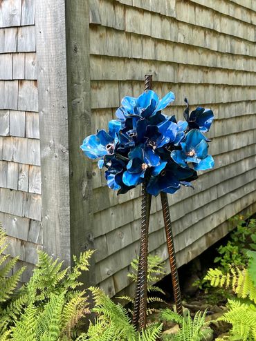 Contemporary blue flower sculpture by Jeff Alarie, steel and copper leaf artwork