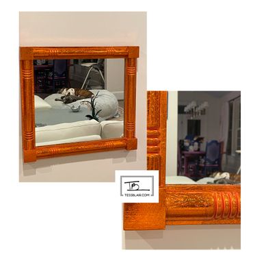 Orange decorative mirror reflecting a cozy living room with dogs resting.