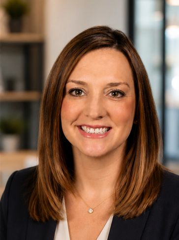 Professional woman smiling in a business setting.